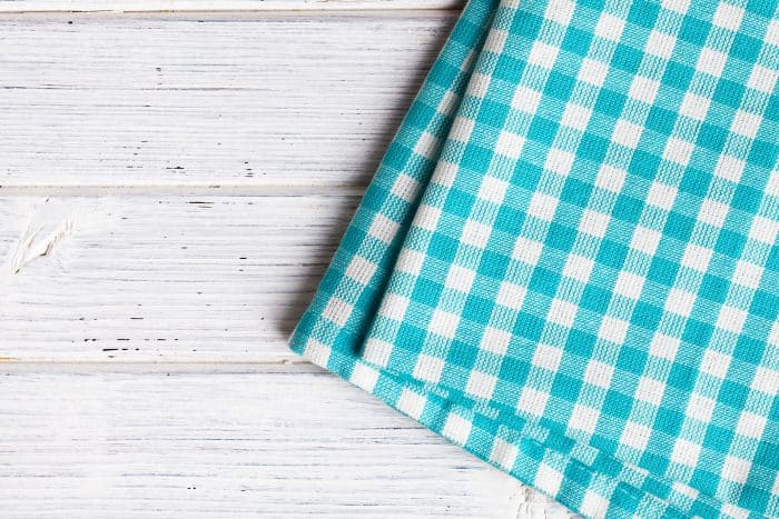 Blue checkered tablecloth on a wooden table